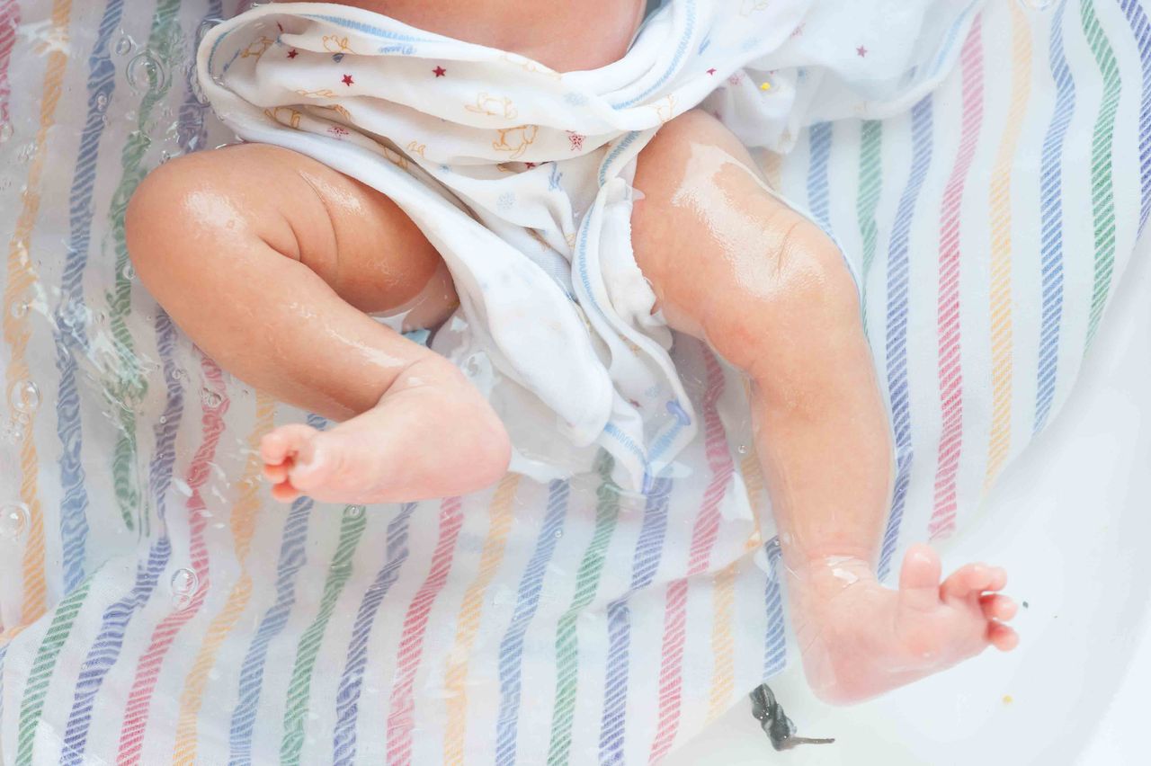 Close-up of a baby's feet on a striped blanket