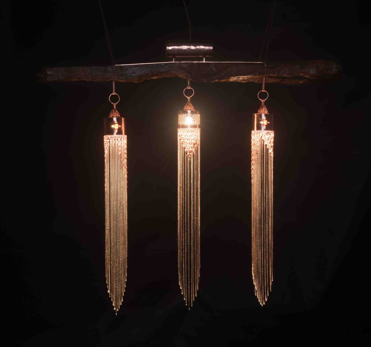 Three gold tassel pendant lights against a black background