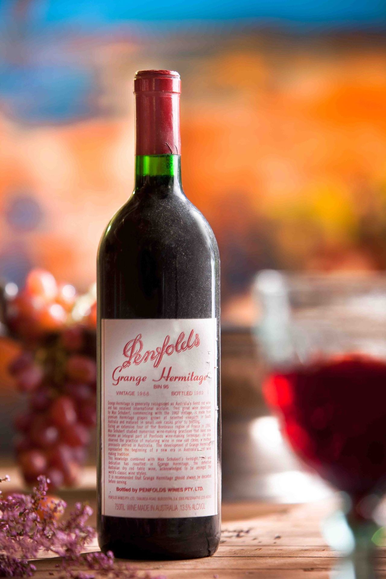 Bottle of red wine beside a glass