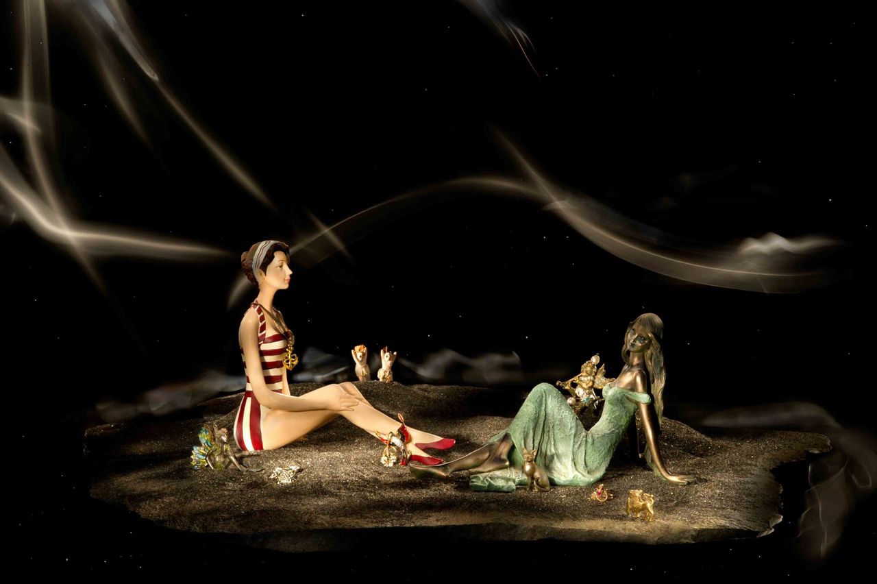 Staged scene of two figurines on a dark set with swirling smoke