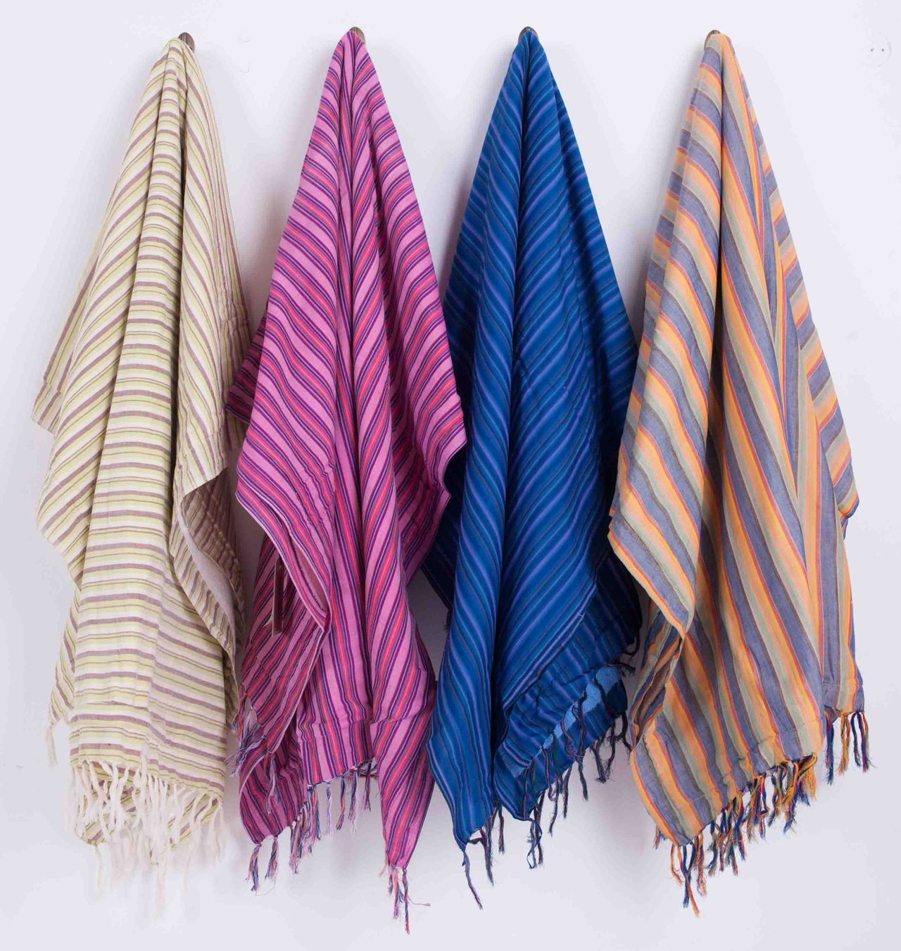 Four woven striped scarves hanging in a row