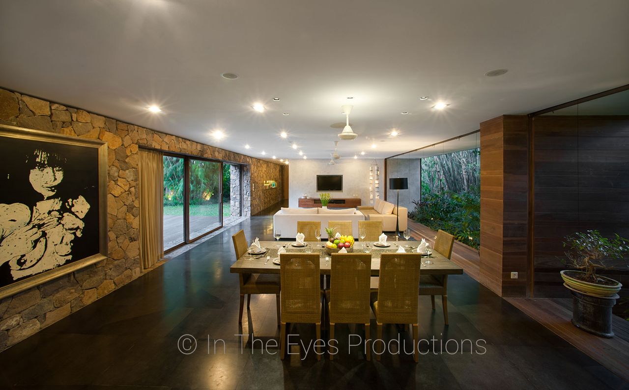 Dining area with a long table in front of a carved feature wall