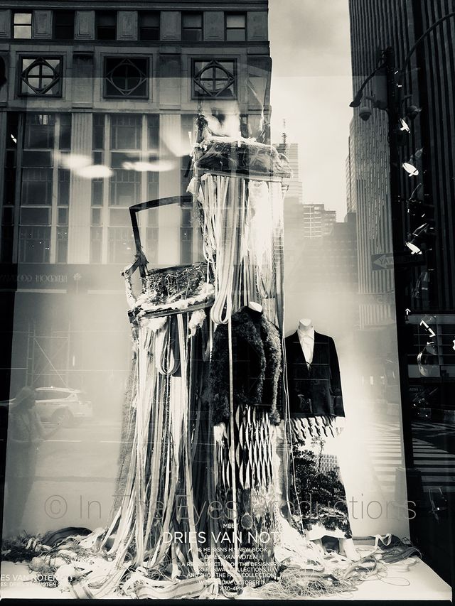 Black-and-white photo of a sculptural dress in a shop window