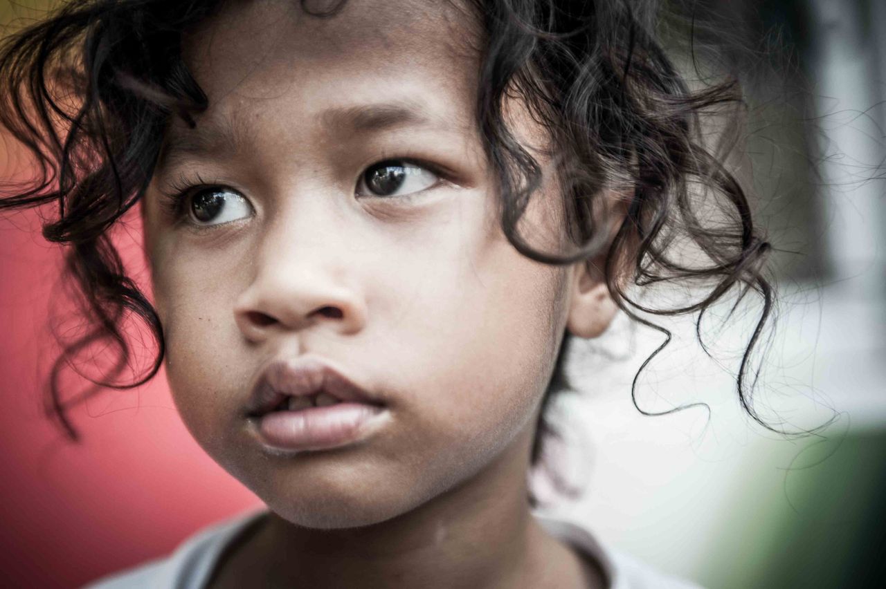 Portrait of a young child with curly dark hair